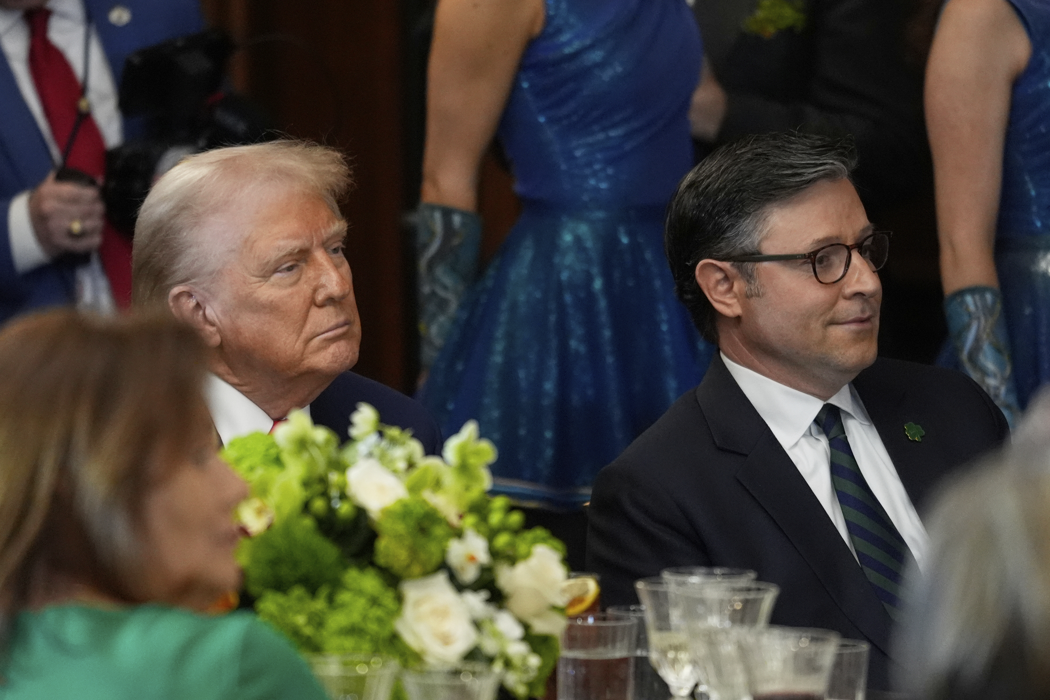 President Donald Trump and House Speaker Mike Johnson of La., listen at the annual St. Patrick's Day luncheon at the Capitol in Washington, Wednesday, March 12, 2025. (AP Photo/J. Scott Applewhite)